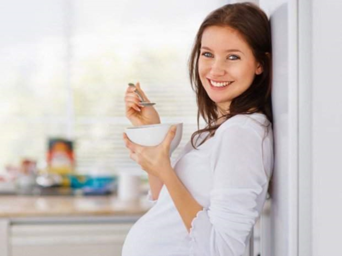 Беременность советы врача. Женщина ест творог.