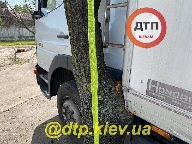 В Киеве неуправляемый грузовик зажал мужчину между авто и деревом