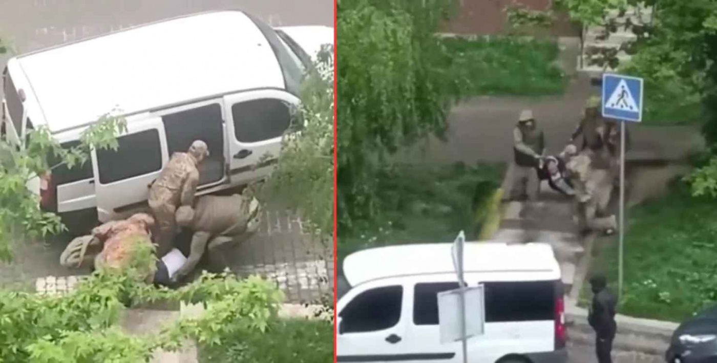 Во Львове военные в форме волокли мужчину в бус по мокрому асфальту